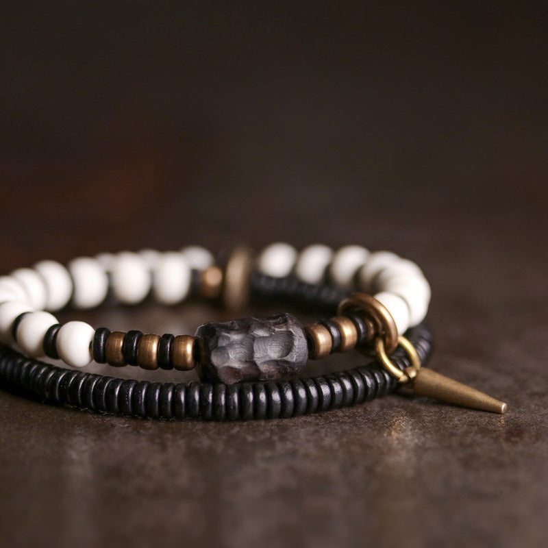 Pulsera de pareja con Buddha Stones, cuentas de hueso, madera de ébano y cobre.