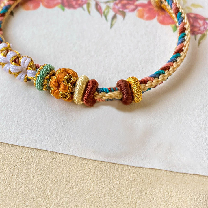 Pulsera de hilo trenzado con diseño de flor de melocotón de color Dunhuang hecha a mano con Buddha Stones