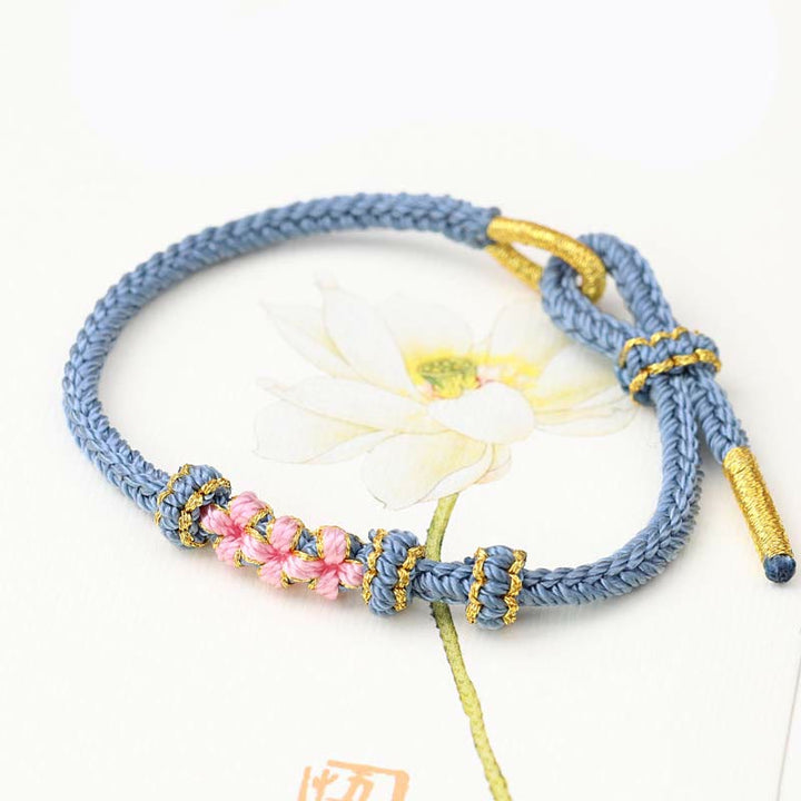 Pulsera de cuerda trenzada de ocho hebras de la suerte con tres flores de melocotón hechas a mano con Buddha Stones