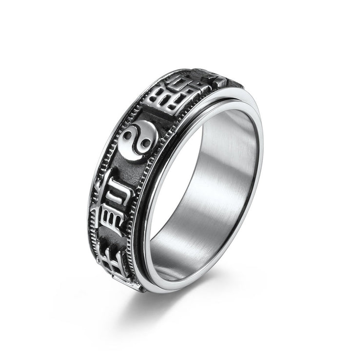 Anillo giratorio de acero titanio con letras en equilibrio y calma