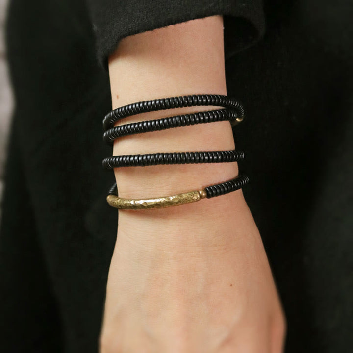 Pulsera multicapa con Buddha Stones, madera de ébano, latón y cobre - image 14