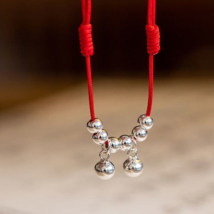 Tobillera con dije de campana trenzada con hilo rojo de plata de ley 925 con Buddha Stones