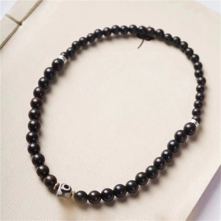 Pulsera de doble envoltura con cuentas Dzi de madera de ébano del Tíbet con Buddha Stones