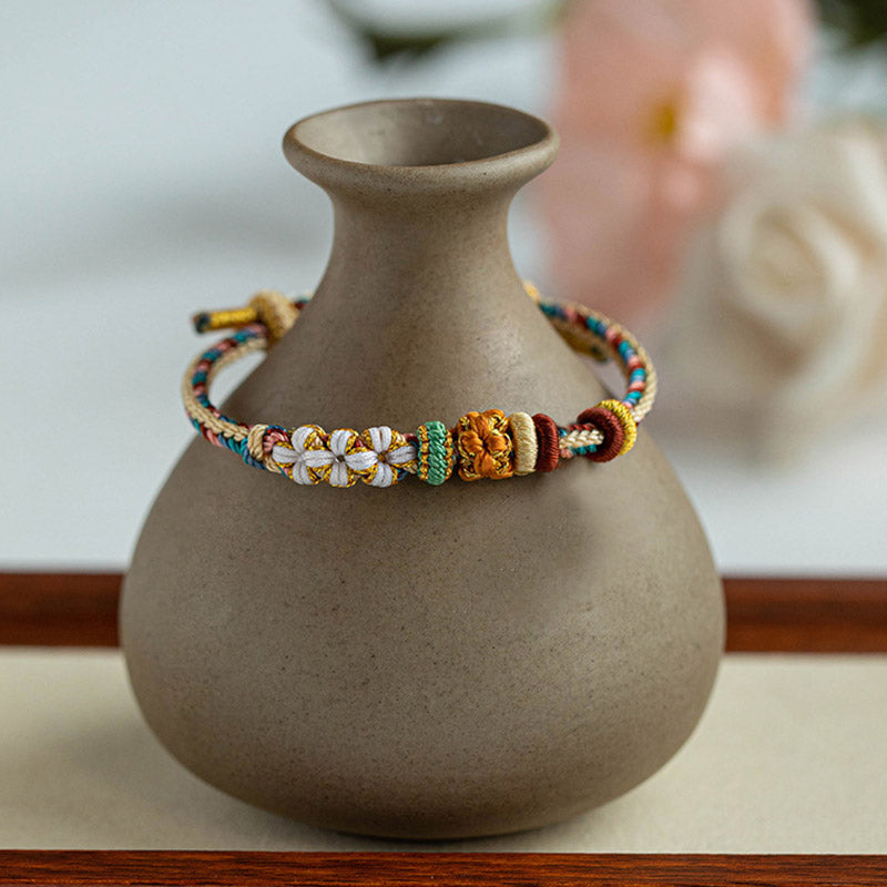 Pulsera de hilo trenzado con diseño de flor de melocotón de color Dunhuang hecha a mano con Buddha Stones