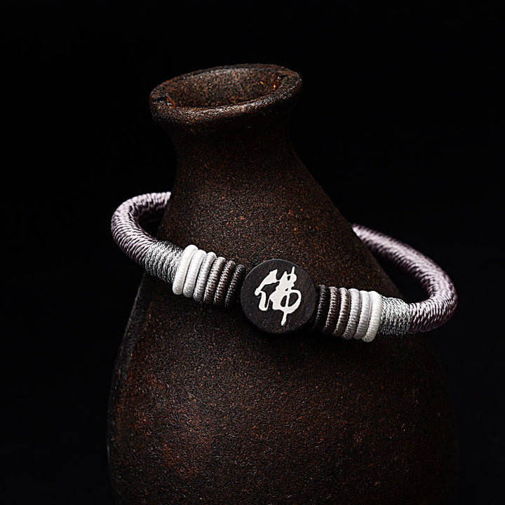 Pulsera de cuerda hecha a mano de ébano con personaje de Buda de Buddha Stones