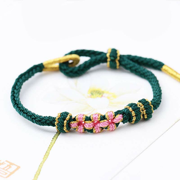 Pulsera de cuerda trenzada de ocho hebras de la suerte con tres flores de melocotón hechas a mano con Buddha Stones