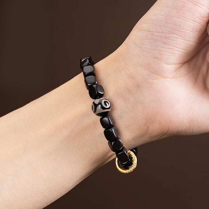 Pulsera de equilibrio de cuentas Dzi de madera de ébano tibetano con Buddha Stones