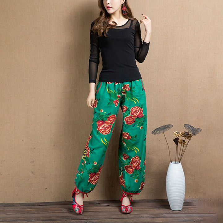 Pantalones bombachos con estampado de flores rojas y verdes de estilo étnico con Buddha Stones y bolsillos