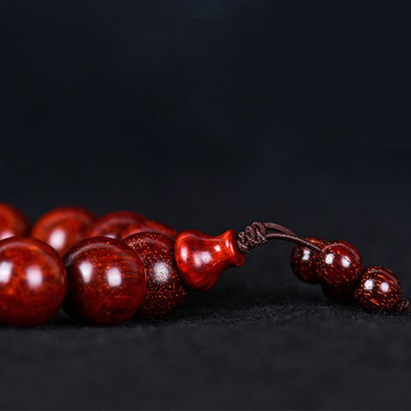 Pulsera de equilibrio de sándalo rojo con hoja pequeña tibetana de Buddha Stones