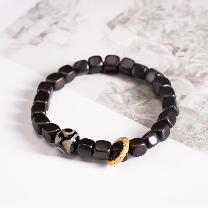 Pulsera de equilibrio de cuentas Dzi de madera de ébano tibetano con Buddha Stones