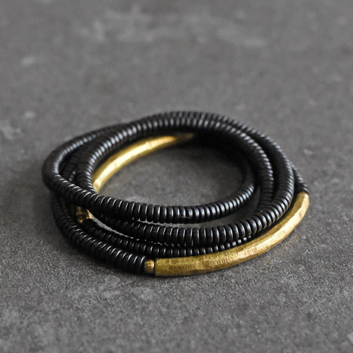 Pulsera multicapa con equilibrio de cobre y madera de ébano con Buddha Stones