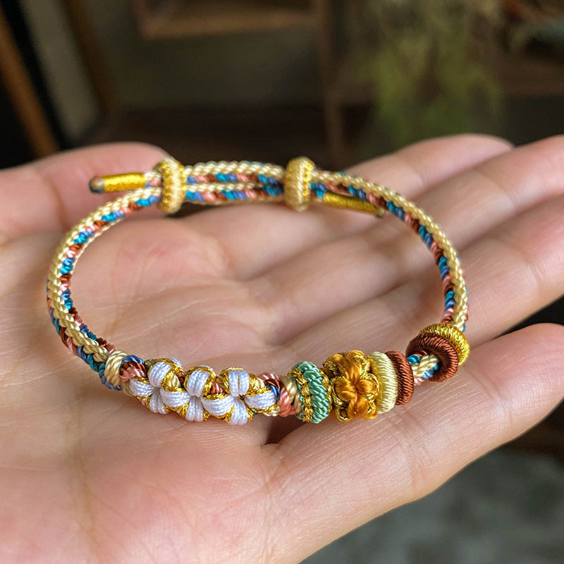 Pulsera de hilo trenzado con diseño de flor de melocotón de color Dunhuang hecha a mano con Buddha Stones