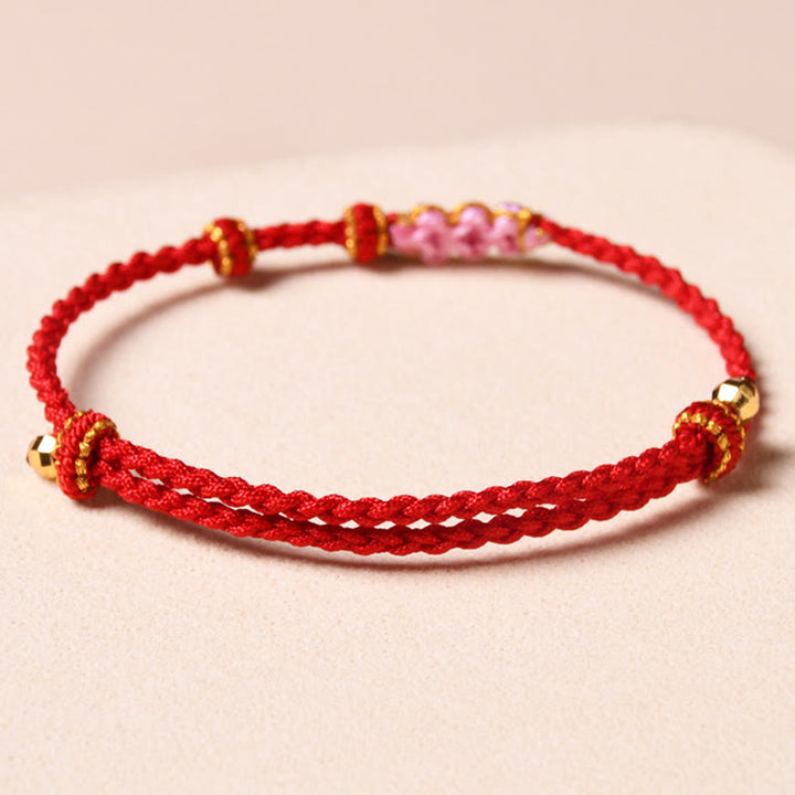 Pulsera de cuerda trenzada con protección de flor de melocotón hecha a mano con Buddha Stones