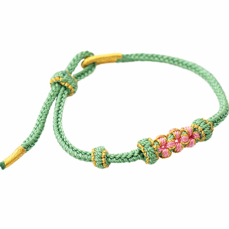 Pulsera de cuerda trenzada de ocho hebras de la suerte con tres flores de melocotón hechas a mano con Buddha Stones