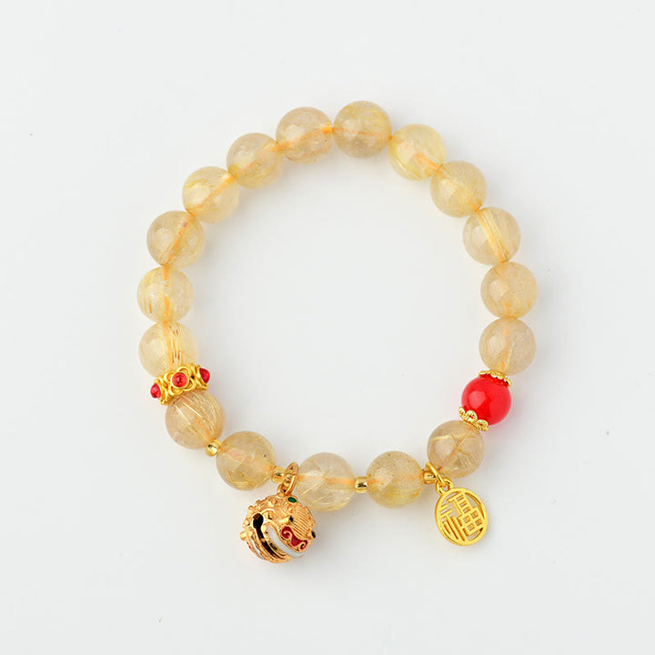 Pulsera de riqueza de campana con dije de personaje Fu de cuarzo rutilado dorado natural con Buddha Stones