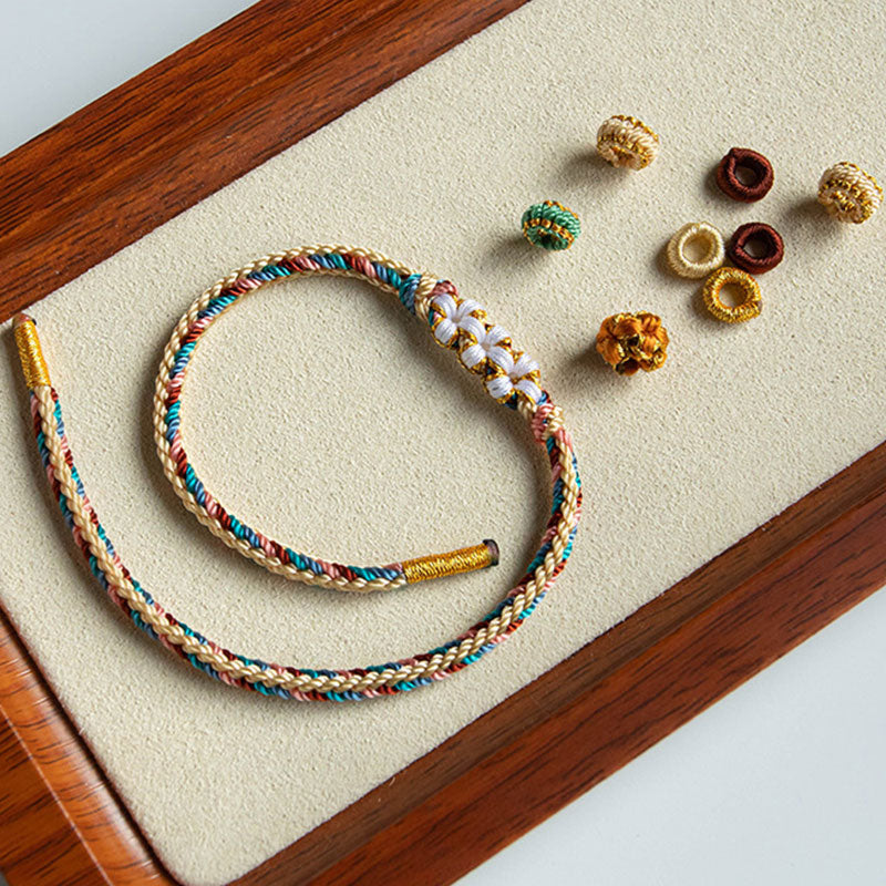 Pulsera de hilo trenzado con diseño de flor de melocotón de color Dunhuang hecha a mano con Buddha Stones