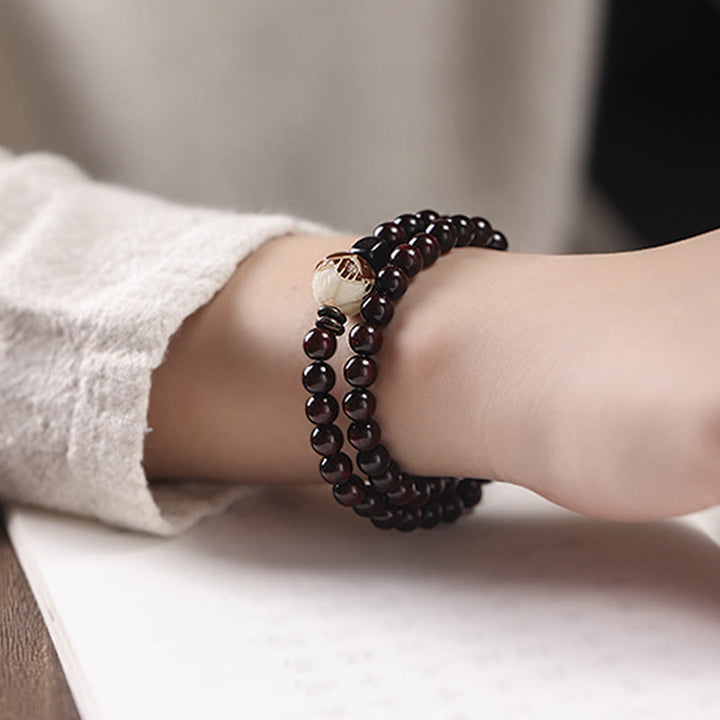 Pulsera de doble envoltura de protección tallada con semillas de loto y sándalo rojo de hoja pequeña de Buddha Stones