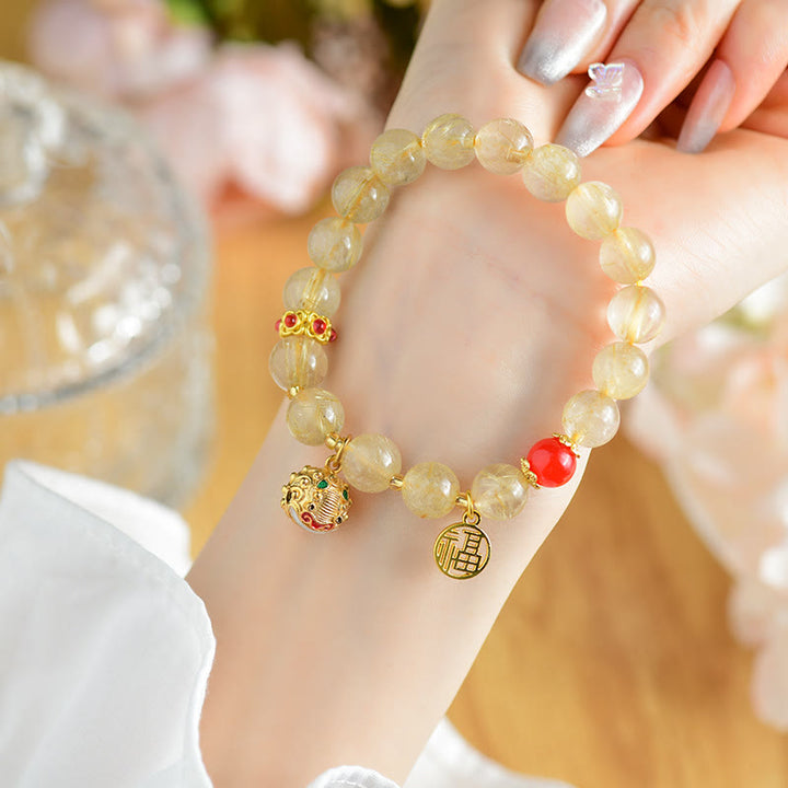 Pulsera de riqueza de campana con dije de personaje Fu de cuarzo rutilado dorado natural con Buddha Stones