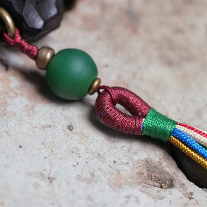 Pulsera Mala de muñeca con borla de paz de cobre y madera de ébano del Tíbet