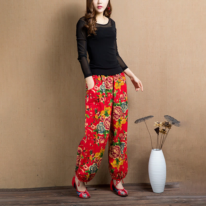 Pantalones bombachos con estampado de flores rojas y verdes de estilo étnico con Buddha Stones y bolsillos