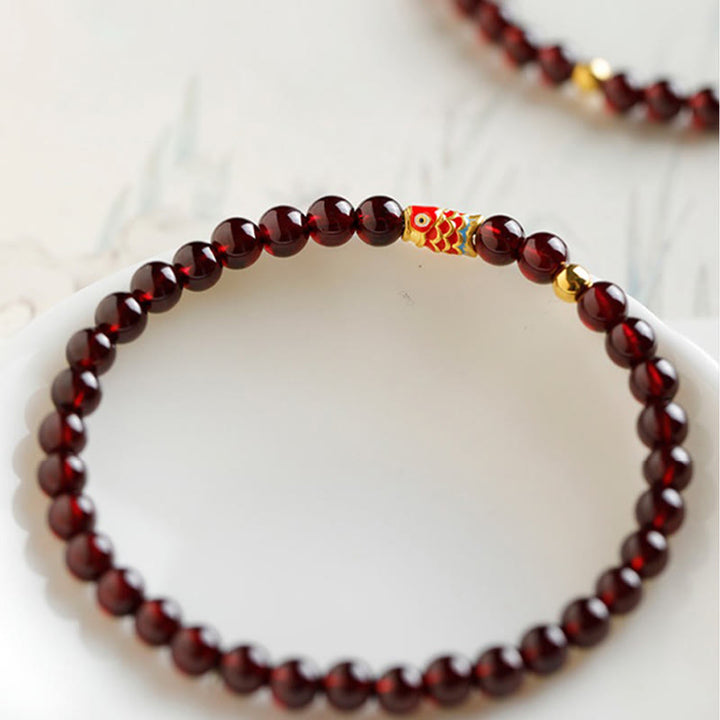Pulsera de protección con granate natural y pez Koi de oro 999 de Buddha Stones - image 4