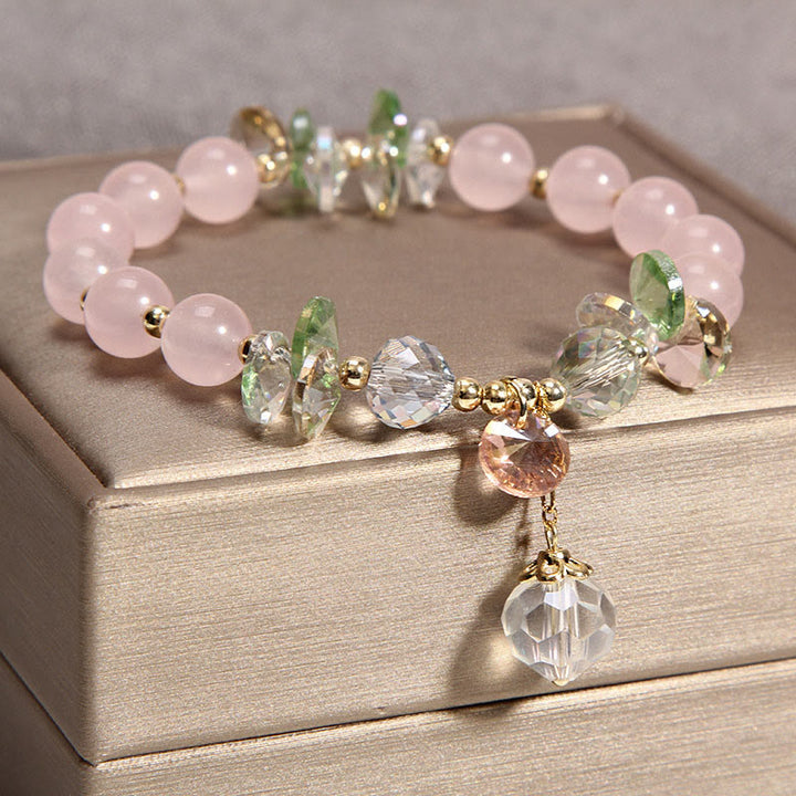 Pulsera con dije de paz y cristal rosa con ojo de gato y Buddha Stones