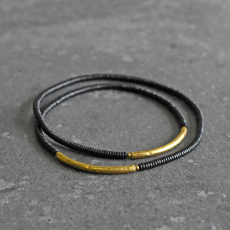 Pulsera multicapa con equilibrio de cobre y madera de ébano con Buddha Stones
