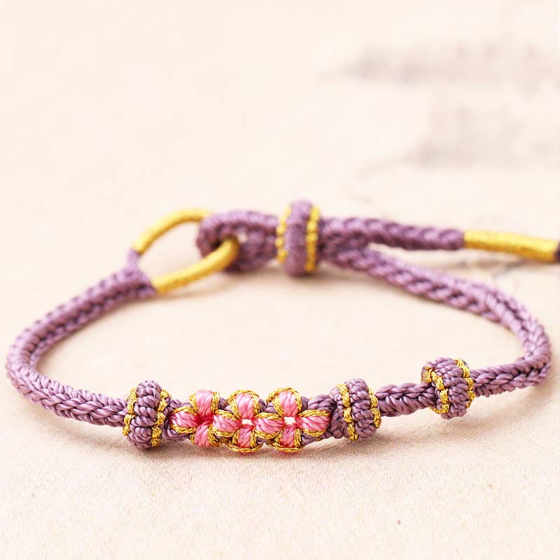 Pulsera de cuerda trenzada de ocho hebras de la suerte con tres flores de melocotón hechas a mano con Buddha Stones