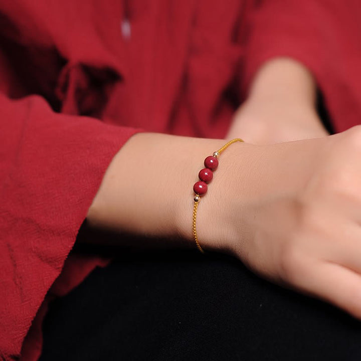 Pulsera trenzada con cadena de bendición de cinabrio natural chapada en oro de 14 quilates con Buddha Stones
