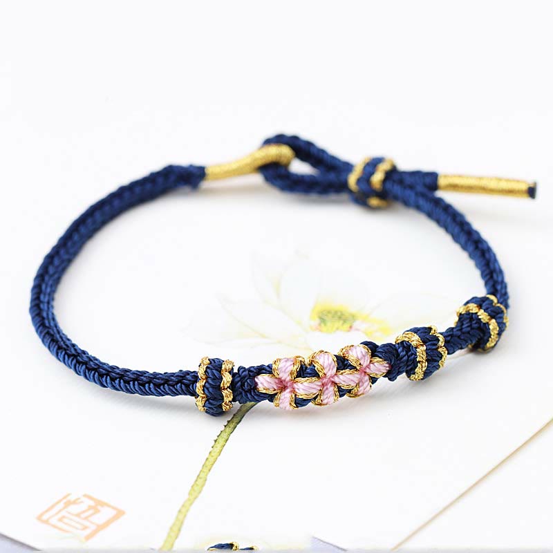 Pulsera de cuerda trenzada de ocho hebras de la suerte con tres flores de melocotón hechas a mano con Buddha Stones