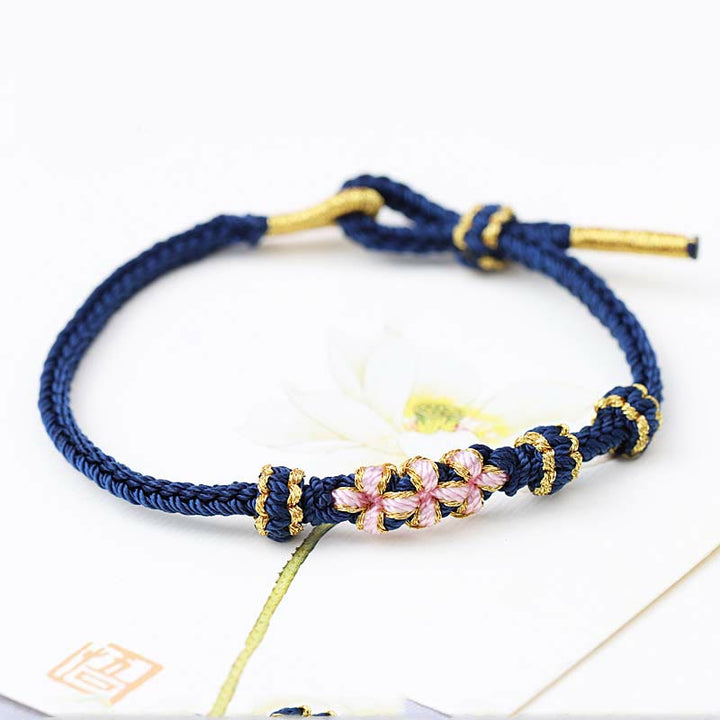 Pulsera de cuerda trenzada de ocho hebras de la suerte con tres flores de melocotón hechas a mano con Buddha Stones