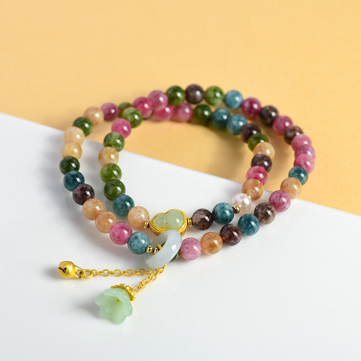 Pulsera con dije de lirio de los valles de doble envoltura de sabiduría de calabaza de turmalina multicolor con Buddha Stones