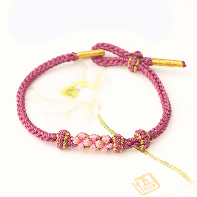 Pulsera de cuerda trenzada de ocho hebras de la suerte con tres flores de melocotón hechas a mano con Buddha Stones