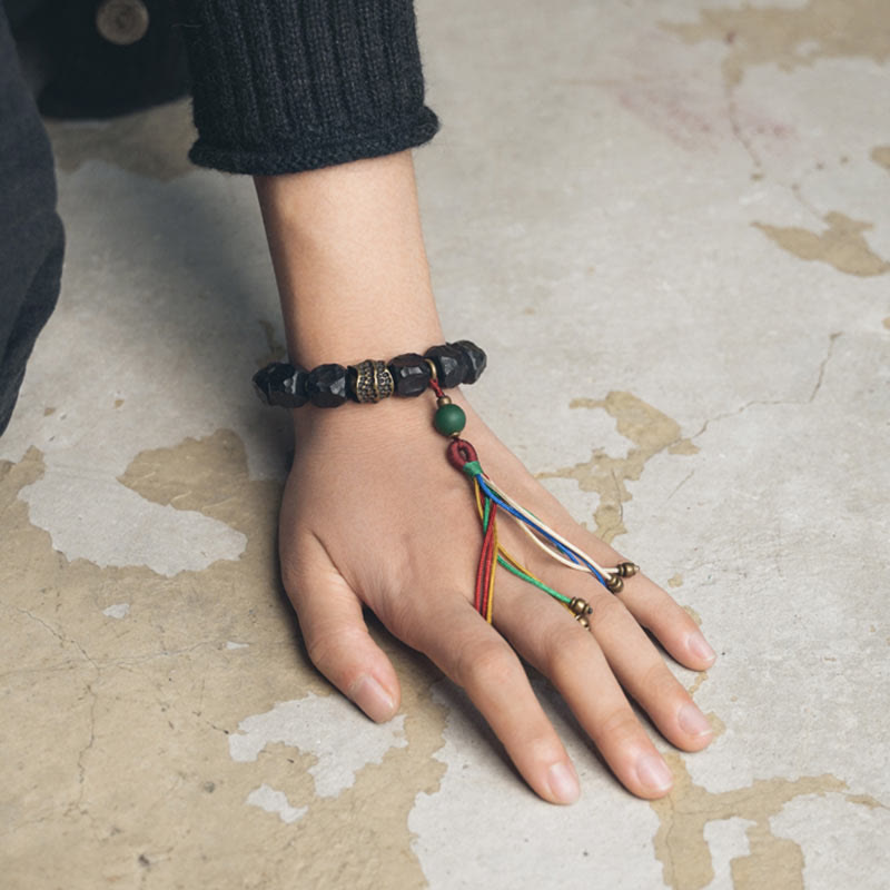 Pulsera Mala de muñeca con borla de paz de cobre y madera de ébano del Tíbet