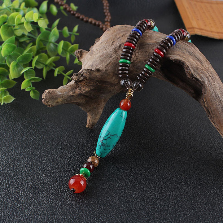Buddha Stones Madera de wengué Piedra turquesa Protección Calma Collar Colgante