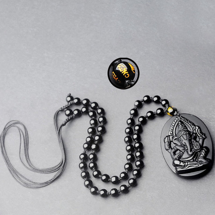 Collar con amuleto de riqueza de elefante Ganesh Ganpati de obsidiana tibetana con Buddha Stones