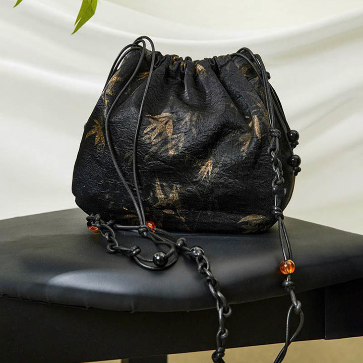Bolso bandolera de acetato con estampado de hojas de bambú amarillo con Buddha Stones
