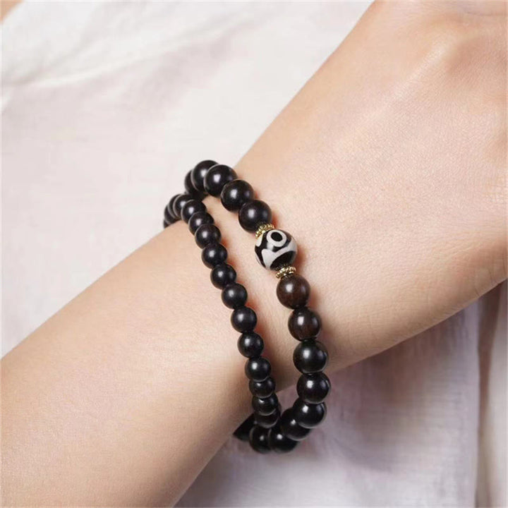 Pulsera de doble envoltura con cuentas Dzi de madera de ébano del Tíbet con Buddha Stones