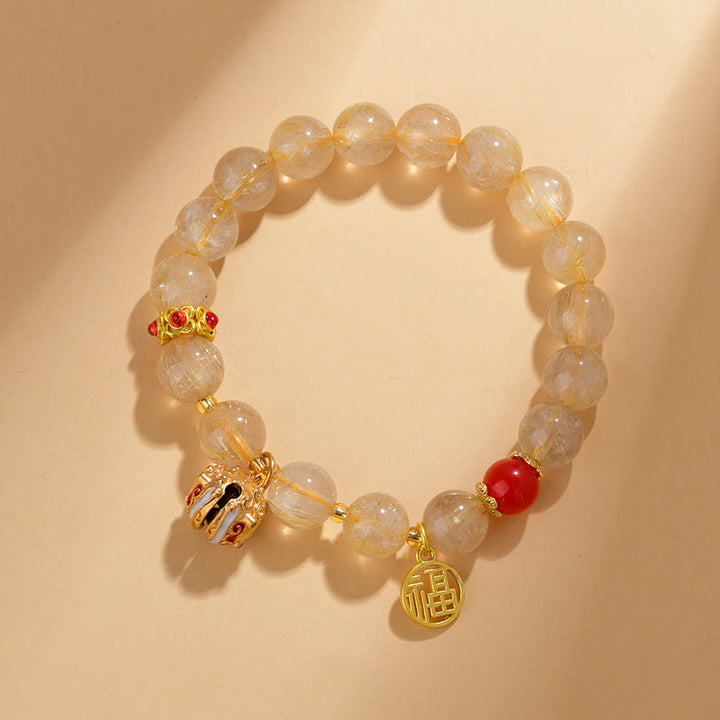 Pulsera de riqueza de campana con dije de personaje Fu de cuarzo rutilado dorado natural con Buddha Stones