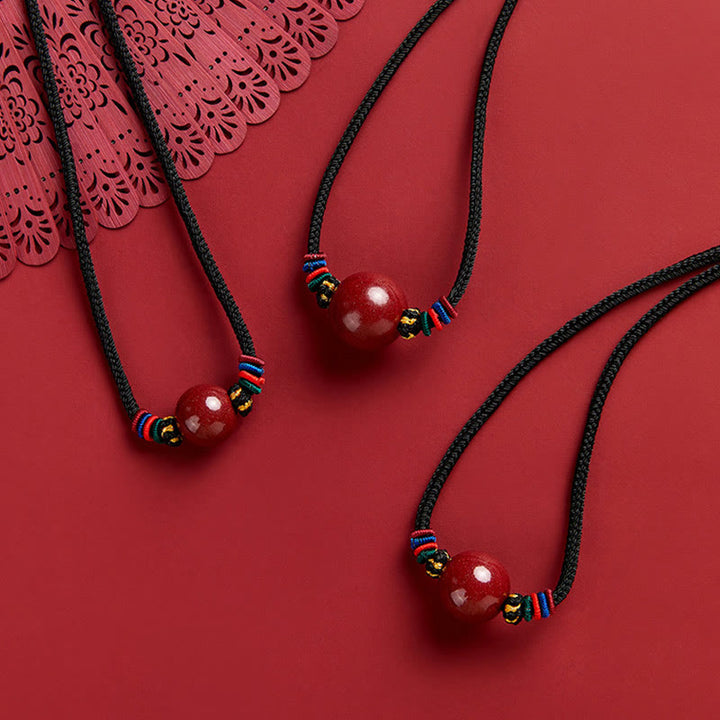 Collar con colgante de cadena con cuentas de cinabrio y Buddha Stones